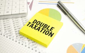 image showing a post it note with 'Double Taxation' on it